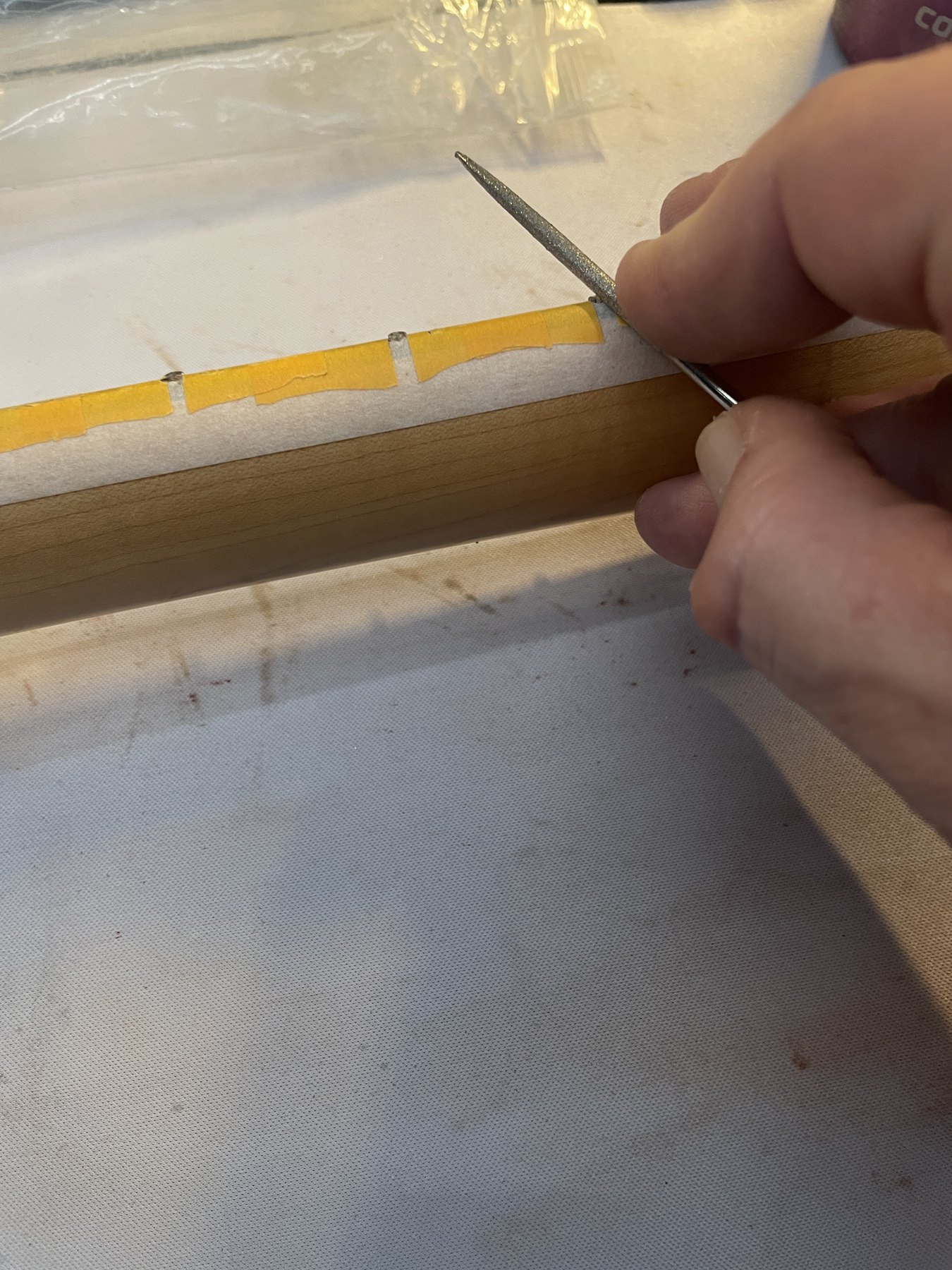 Dressing fret ends and filing tangs flush with the fingerboard
