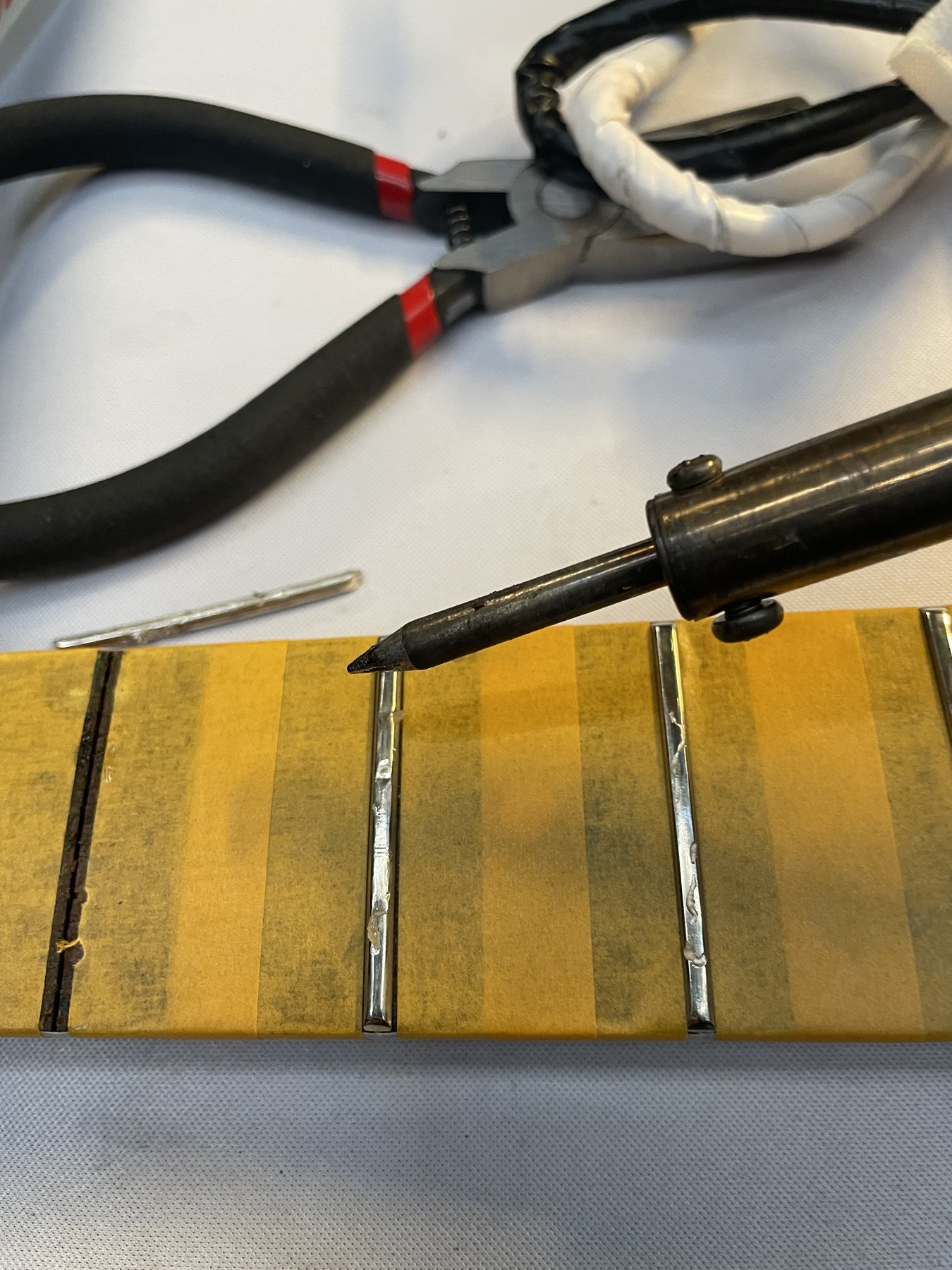 Localized heat applied to an original Pacifica 921 fret before extraction