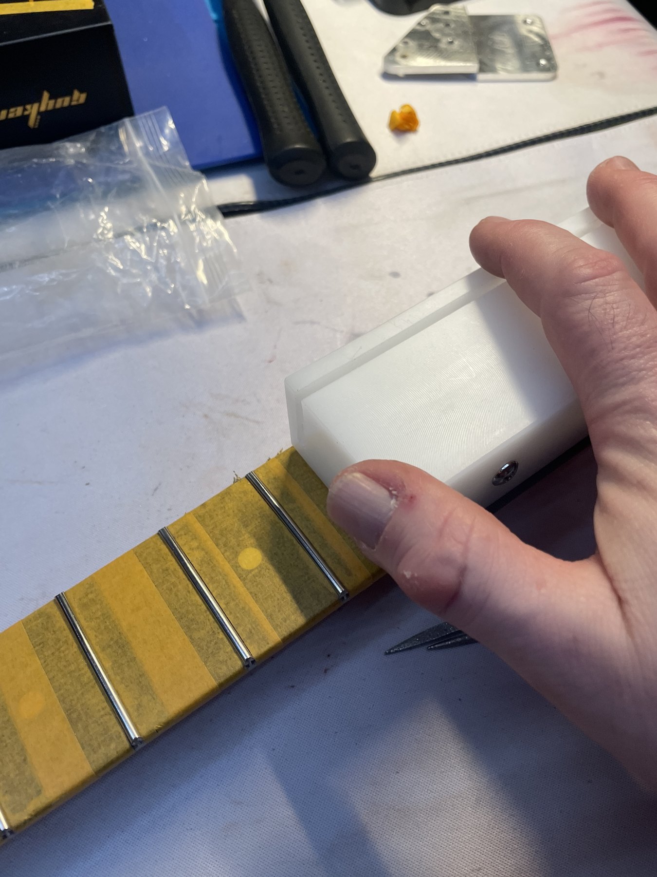 Seating newly installed fretwire on the protected fingerboard